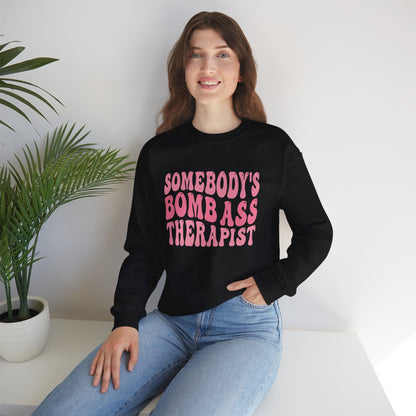 Somebody’s Bomb Ass Therapist (Pink) Crewneck