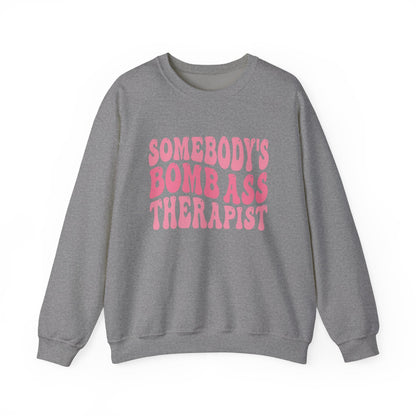 Somebody’s Bomb Ass Therapist (Pink) Crewneck Printify